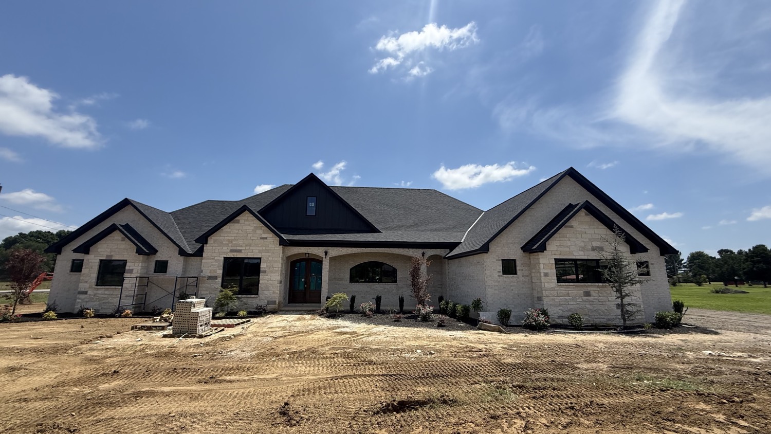 Cream limestone custom home L&L is building in the River Valley