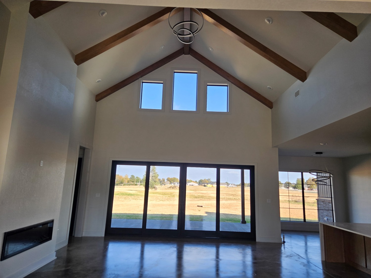 Vaulted great room with timber beams and glass walls