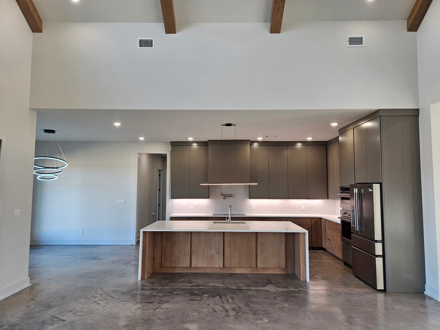 Custom kitchen with oak island and taupe cabinets